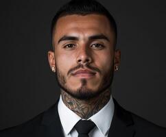 Professional portrait of a young man in a suit with tattoos photo