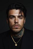 Striking portrait of a man with tattoos and elegant attire in low light photo