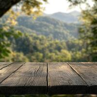 Sunny day with a wooden tabletop and blurred forest view photo