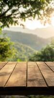 Wooden table overlooking a lush valley at sunset in a serene setting photo