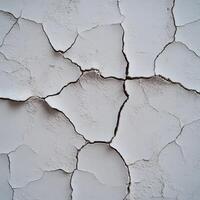 Cracked white wall texture showing signs of weathering and age photo