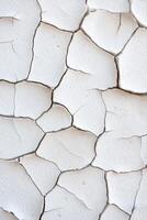 Cracked white wall surface showing texture and aging in natural light photo