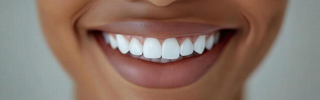 Bright smile of a person showcasing healthy teeth in natural light photo