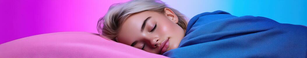 A young woman peacefully sleeps wrapped in a blue blanket at night photo