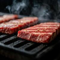Juicy beef steaks grilling on a barbecue in a smoky outdoor setting photo