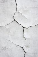 Cracked white plaster wall texture with visible fissures and lines photo