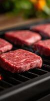 Grilling fresh beef steaks on a barbecue during summer cookout photo