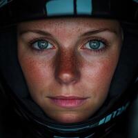Determined female racer in helmet before competition photo