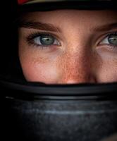 Close-up of a female race car driver wearing a helmet before the race photo