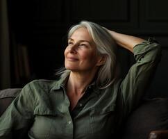 A thoughtful woman relaxing on a couch in a cozy, dimly lit room photo