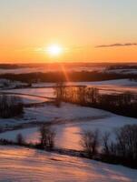 Golden sunset over snowy fields and trees in a peaceful landscape photo