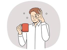 Sleepy man with mug of coffee, opens eyes with hand and needs to rest due to lack of energy vector