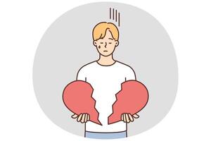 Unhappy man hold broken heart in hands vector