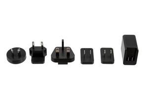 A set of international power plug adapters and a power adapter, designed for travelers to connect electronic devices in various countries, showcased against a white back photo