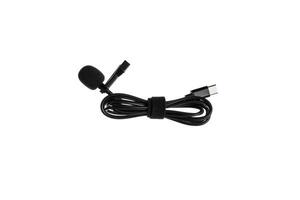 A black lavalier microphone with a foam windscreen and a USB-C connector, neatly coiled with a Velcro strap, isolated on a white back photo