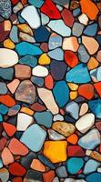 Colorful smooth pebbles tightly packed, creating a vibrant mosaic pattern. Multicolored background. photo