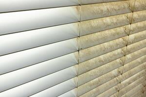 Residential Window Shades Showing the Before and After of a Good Cleaning - One Side Clean and One Side Dirty. photo