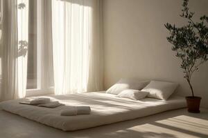 White bed with a potted plant next to it photo
