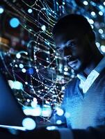 Man is looking at a computer screen with a blue background photo