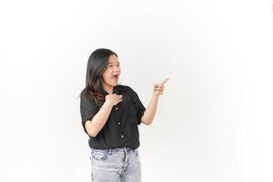 beautiful Asian woman with a shocked expression points emphatically, highlighting surprise against a white background photo
