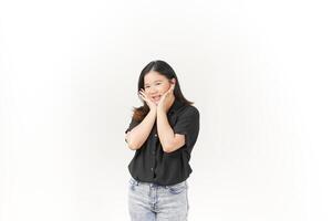 beautiful Asian woman gently holds her cheeks with both palms, showcasing a soft expression against a white background photo