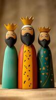 Charming wooden figurines of the Three Kings with simple golden crowns. Epiphany vertical image photo