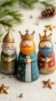 Whimsical wooden figurines of the Three Kings with golden crowns and robes. Epiphany vertical image photo