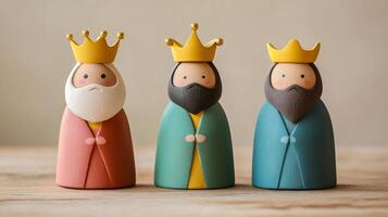 Charming wooden figurines of the Three Kings with simple, soft colors and golden crowns. Epiphany photo