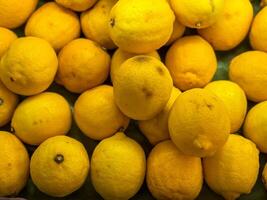 Raw lemon heap on market show tray photo