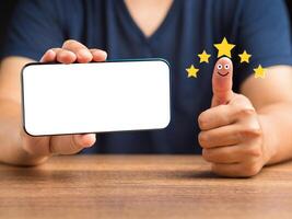 Hand with thumb up for smiley face icon. Best excellent services for satisfaction client giving a five-star rating photo