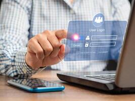 Businessman touching login button to the network system on a virtual screen photo