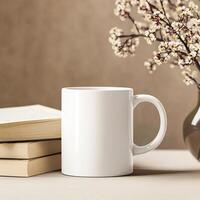 A white mug and a stack of books on a table photo