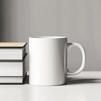 A white mug and a stack of books on a table photo