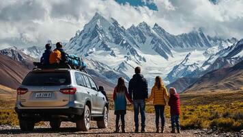 A family is standing on the back of a suv with mountains in the background video