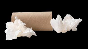 Side view of screwed or crumpled white tissue paper ball with cores or tube in stack isolated on black background with clipping path photo