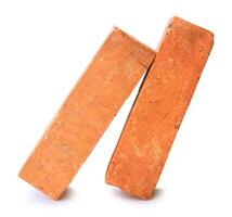 Side view of old red or orange bricks in stack isolated on white background with clipping path photo