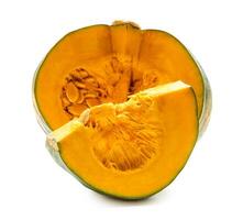 Side view of fresh green japanese pumpkin with slices or pieces in stack isolated on white background with clipping path photo