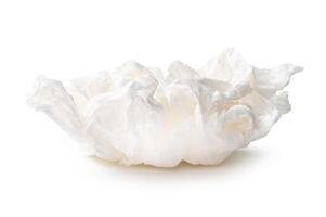 Side view of screwed or crumpled white tissue paper ball isolated on white background with clipping path photo