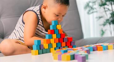 Children enjoy colourful game with educational toy blocks that make play fun activity, enhancing their development during childhood. gathering, creation, exercise, inspiration, improvement, practice. photo