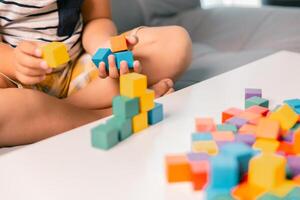 Children enjoy colourful game with educational toy blocks that make play fun activity, enhancing their development during childhood. gathering, creation, exercise, inspiration, improvement, practice. photo