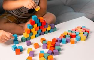 Children enjoy colourful game with educational toy blocks that make play fun activity, enhancing their development during childhood. gathering, creation, exercise, inspiration, improvement, practice. photo