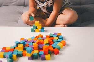 Children enjoy colourful game with educational toy blocks that make play fun activity, enhancing their development during childhood. gathering, creation, exercise, inspiration, improvement, practice. photo