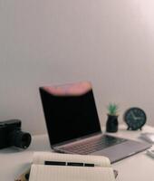 Remote work relies on technology, with employees using laptops and computers from home to communicate and conduct business online via network. comfortable, display, efficient, electronic, minimalist. photo