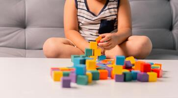 Children enjoy colourful game with educational toy blocks that make play fun activity, enhancing their development during childhood. gathering, creation, exercise, inspiration, improvement, practice. photo
