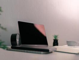 Remote work relies on technology, with employees using laptops and computers from home to communicate and conduct business online via network. comfortable, display, efficient, electronic, minimalist. photo
