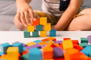 Children enjoy colourful game with educational toy blocks that make play fun activity, enhancing their development during childhood. gathering, creation, exercise, inspiration, improvement, practice. photo