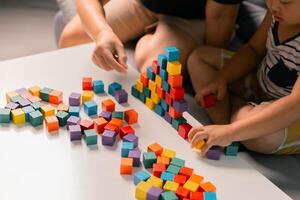 Children enjoy colourful game with educational toy blocks that make play fun activity, enhancing their development during childhood. gathering, creation, exercise, inspiration, improvement, practice. photo
