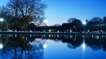 The peaceful city night view with the lights on and the reflections in water photo