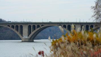 One arched bridge cross the wide river in the city of Washington DC photo