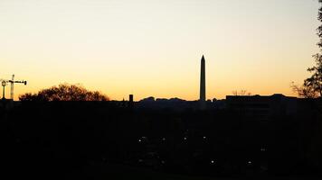 The beautiful sunset city view with the silhouette of the monument tower in Washington DC photo